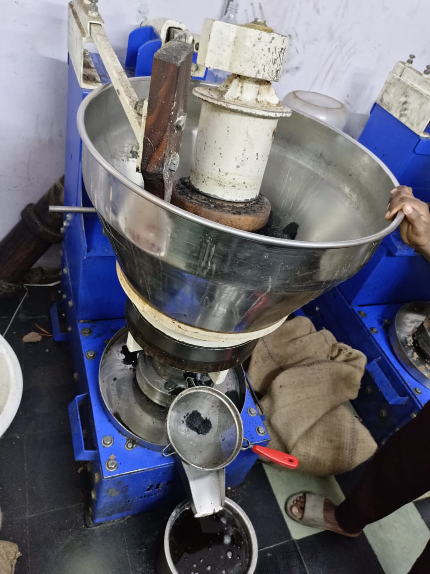 Freshly pressed oil running through the sieve — Cold-press unit